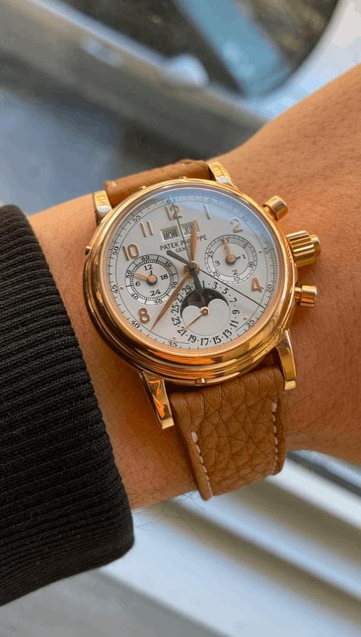 Rose gold Patek Philippe perpetual calendar chronograph with moon phase on a tan leather strap